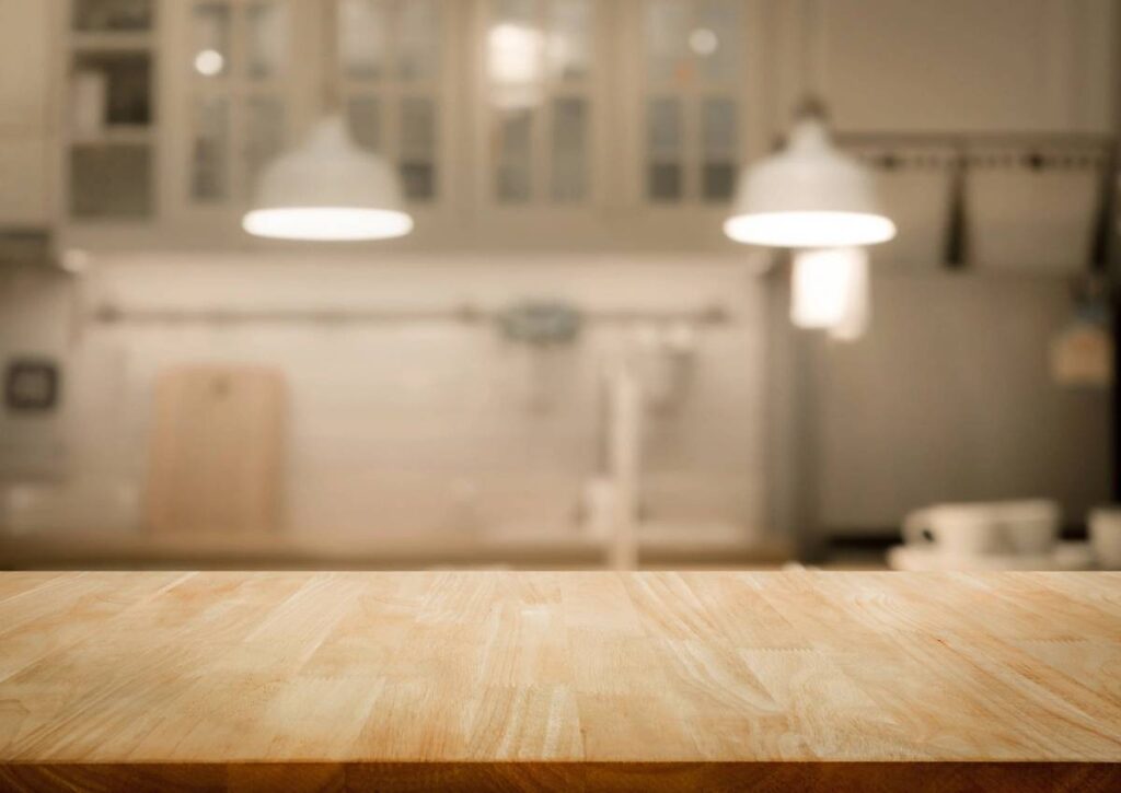 Wood table top on blur kitchen room background .For montage product display or design key visual layout.